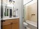 This is a tiled bathroom with a shower-tub combination, and a wood vanity with a light countertop at 461 Bartram Se St # A, Atlanta, GA 30316