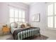 Charming bedroom with a black iron bed frame, plantation shutters, and pastel lavender walls at 461 Bartram Se St # A, Atlanta, GA 30316