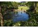 Scenic community view featuring a pond with fountain, wooden footbridges and a lush playground area at 461 Bartram Se St # A, Atlanta, GA 30316