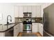 Modern kitchen with stainless steel appliances, granite countertops, and white cabinets, with hardwood floors at 461 Bartram Se St # A, Atlanta, GA 30316