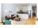 Open-concept living room with a view of the kitchen, hardwood floors, and modern furnishings at 461 Bartram Se St # A, Atlanta, GA 30316