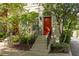 Charming townhouse with red front door and well-maintained landscaping with stairs and iron railing at 461 Bartram Se St # A, Atlanta, GA 30316