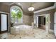 Large bathroom featuring a soaking tub under a window and tile surround at 95 Grogans Lndg, Atlanta, GA 30350