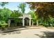 Charming white brick building with an arched entrance and beautifully landscaped surroundings, creating an inviting and picturesque setting at 95 Grogans Lndg, Atlanta, GA 30350