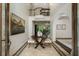 Elegant foyer showcases a curved staircase, decorative tile flooring, and an arched doorway into another living space at 95 Grogans Lndg, Atlanta, GA 30350