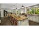 The kitchen island boasts a granite countertop, custom cabinets, and modern pendant lighting, creating a functional and stylish space at 95 Grogans Lndg, Atlanta, GA 30350