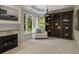 Elegant living room featuring a fireplace, large windows with natural light, and a custom-built bookshelf at 95 Grogans Lndg, Atlanta, GA 30350