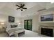 Light-filled bedroom suite features a tray ceiling, fireplace, and French doors to a private balcony at 95 Grogans Lndg, Atlanta, GA 30350
