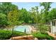 Relaxing pool area with lounge chairs, lush greenery and recreation area, providing a perfect spot for outdoor enjoyment and leisure at 95 Grogans Lndg, Atlanta, GA 30350
