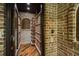 Custom wine cellar with brick walls and wood storage racks at 95 Grogans Lndg, Atlanta, GA 30350