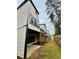 A view of the back of the house with a wooden deck, a concrete patio, and a manicured lawn at 1320 Stanley Park Dr # 141, Decatur, GA 30033