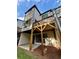 A back view showcasing a home's elevated wooden deck and a cozy concrete patio beneath at 1320 Stanley Park Dr # 141, Decatur, GA 30033