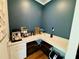 Cozy coffee bar with white countertops, custom cabinets, hardwood flooring, and blue painted walls at 1320 Stanley Park Dr # 141, Decatur, GA 30033