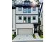 Beautiful three-story home with a gray garage door, white brick, black trim, and decorative door wreath at 1320 Stanley Park Dr # 141, Decatur, GA 30033