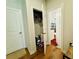 Hallway featuring wood floors, white walls, and access to closet at 1320 Stanley Park Dr # 141, Decatur, GA 30033