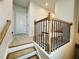 Hallway featuring stairs with carpet, decorative railings, neutral paint and bright ambient lighting at 1320 Stanley Park Dr # 141, Decatur, GA 30033