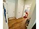 Hallway featuring wood floors, white walls, and access to bathroom at 1320 Stanley Park Dr # 141, Decatur, GA 30033