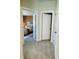 Hallway featuring an open doorway to a bedroom with carpeted floors and neutral paint at 1320 Stanley Park Dr # 141, Decatur, GA 30033