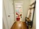 Hallway view leading to bathroom; includes hardwood floors and coat rack with bench at 1320 Stanley Park Dr # 141, Decatur, GA 30033