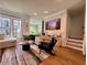 Cozy living room with hardwood floors, modern furniture, a large rug, and an entertainment center at 1320 Stanley Park Dr # 141, Decatur, GA 30033