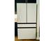 Modern white refrigerator with sleek black trim provides ample storage space in this contemporary kitchen at 1320 Stanley Park Dr # 141, Decatur, GA 30033