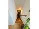 Well-lit staircase featuring wood stairs, modern lighting, and natural plants at 1320 Stanley Park Dr # 141, Decatur, GA 30033
