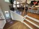 Elegant staircase with wood railings and black metal balusters leads to a dining area with counter seating at 1320 Stanley Park Dr # 141, Decatur, GA 30033