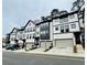 A street view of new townhomes with a modern design featuring garages and well-manicured landscaping at 1320 Stanley Park Dr # 141, Decatur, GA 30033
