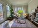 Bright sunroom with large windows and lush plants, creating a relaxing and inviting space at 1320 Stanley Park Dr # 141, Decatur, GA 30033