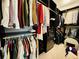 Organized walk-in closet with black shelving, drawers, hanging rods and neutral carpet at 1320 Stanley Park Dr # 141, Decatur, GA 30033