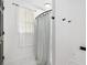 Bathroom featuring white marble floors and a shower with a patterned shower curtain at 4205 Mabry Ne Rd, Roswell, GA 30075