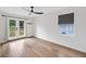 Bright bedroom with hardwood floors, ceiling fan and french doors leading to an outdoor deck at 4205 Mabry Ne Rd, Roswell, GA 30075