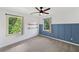 Bedroom featuring modern wainscoting, a ceiling fan, and windows offering an outside view at 4205 Mabry Ne Rd, Roswell, GA 30075