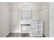 Walk-in closet offers ample storage with white shelves and hanging rods at 4205 Mabry Ne Rd, Roswell, GA 30075
