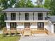 Front exterior featuring a two-story facade with a balcony, fresh paint, and landscaping at 4205 Mabry Ne Rd, Roswell, GA 30075
