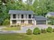 Charming two-story home with a gray roof, white siding and a well-maintained front yard at 4205 Mabry Ne Rd, Roswell, GA 30075