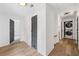 Hallway with hard wood floors, access to the laundry room and a bedroom at 4205 Mabry Ne Rd, Roswell, GA 30075