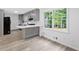 Modern kitchen with gray cabinets, sleek countertops, a breakfast bar and stainless steel appliances at 4205 Mabry Ne Rd, Roswell, GA 30075
