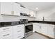Modern kitchen with stainless steel appliances, white cabinets, and elegant countertops at 4205 Mabry Ne Rd, Roswell, GA 30075
