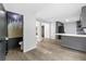 Open-concept view of the kitchen with modern appliances and updated flooring leading to a half bath at 4205 Mabry Ne Rd, Roswell, GA 30075