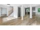 Open living area with a staircase, gray-themed interior, and a modern kitchen nearby at 4205 Mabry Ne Rd, Roswell, GA 30075