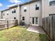 Private backyard with a small patio, partial fence, and grassy area at 4922 Longview Walk, Decatur, GA 30035