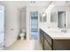 Bright bathroom with double sinks, tile floors, and a view into the adjacent room at 4922 Longview Walk, Decatur, GA 30035