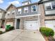 Charming townhome showcasing stone accents, a single-car garage, and well-maintained landscaping at 4922 Longview Walk, Decatur, GA 30035