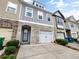Charming townhome showcasing stone accents, a single-car garage, and well-maintained landscaping at 4922 Longview Walk, Decatur, GA 30035