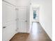 Inviting hallway features sleek wood floors, white walls, and well-lit access to the home's entry door at 4922 Longview Walk, Decatur, GA 30035