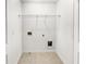 Functional laundry room with tile flooring and utility connections, ready for appliances and storage solutions at 4922 Longview Walk, Decatur, GA 30035