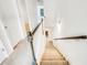 Carpeted staircase with white walls and a wooden handrail leading to the lower level at 4922 Longview Walk, Decatur, GA 30035