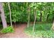 Wooded backyard featuring a charming, rustic wooden fence providing a private outdoor space surrounded by lush greenery at 4957 Day Lily Nw Way, Acworth, GA 30102