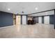 Spacious finished basement with tile flooring, bar, and multiple doorways at 4957 Day Lily Nw Way, Acworth, GA 30102